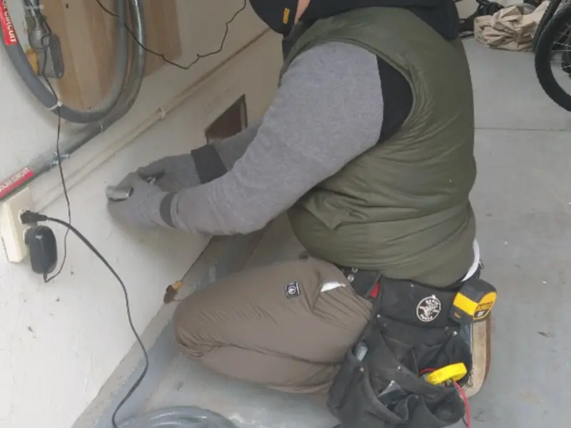 Electrician performing outlet wiring in a Coquille garage